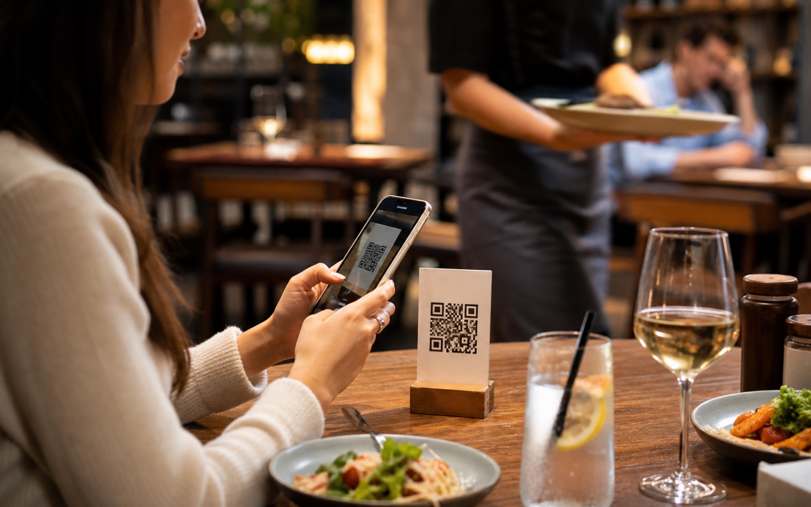 Diner scanning a QR code at a restaurant table to order food